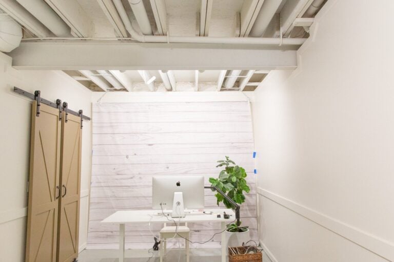 Exposed basement ceiling painted white