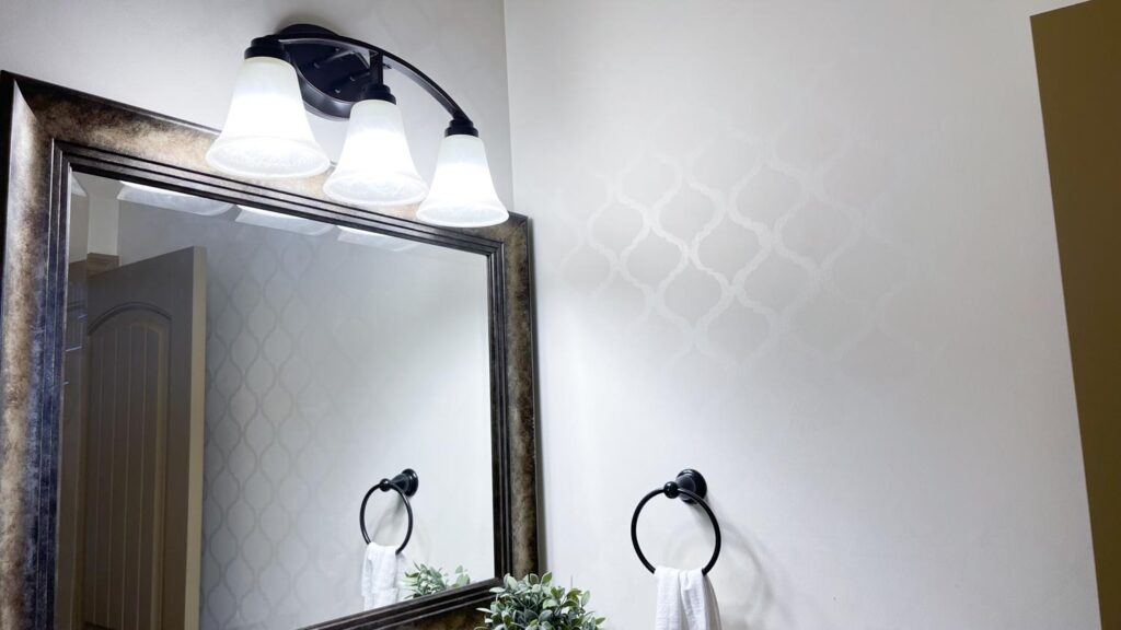 patterned wall bathroom with same color different sheen mirror and wall