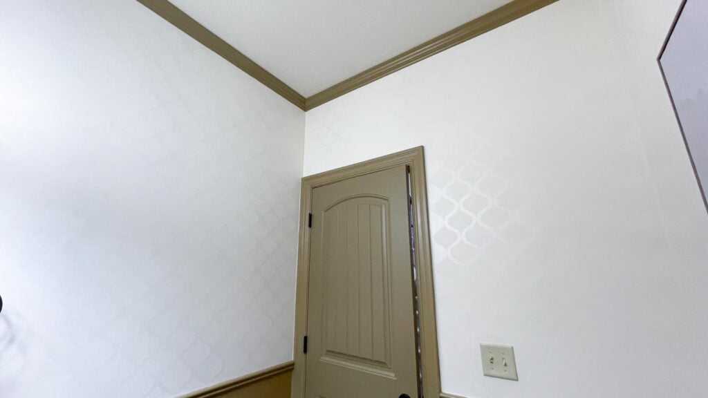 diy wall pattern paint with same color different sheen next to door and hallway
