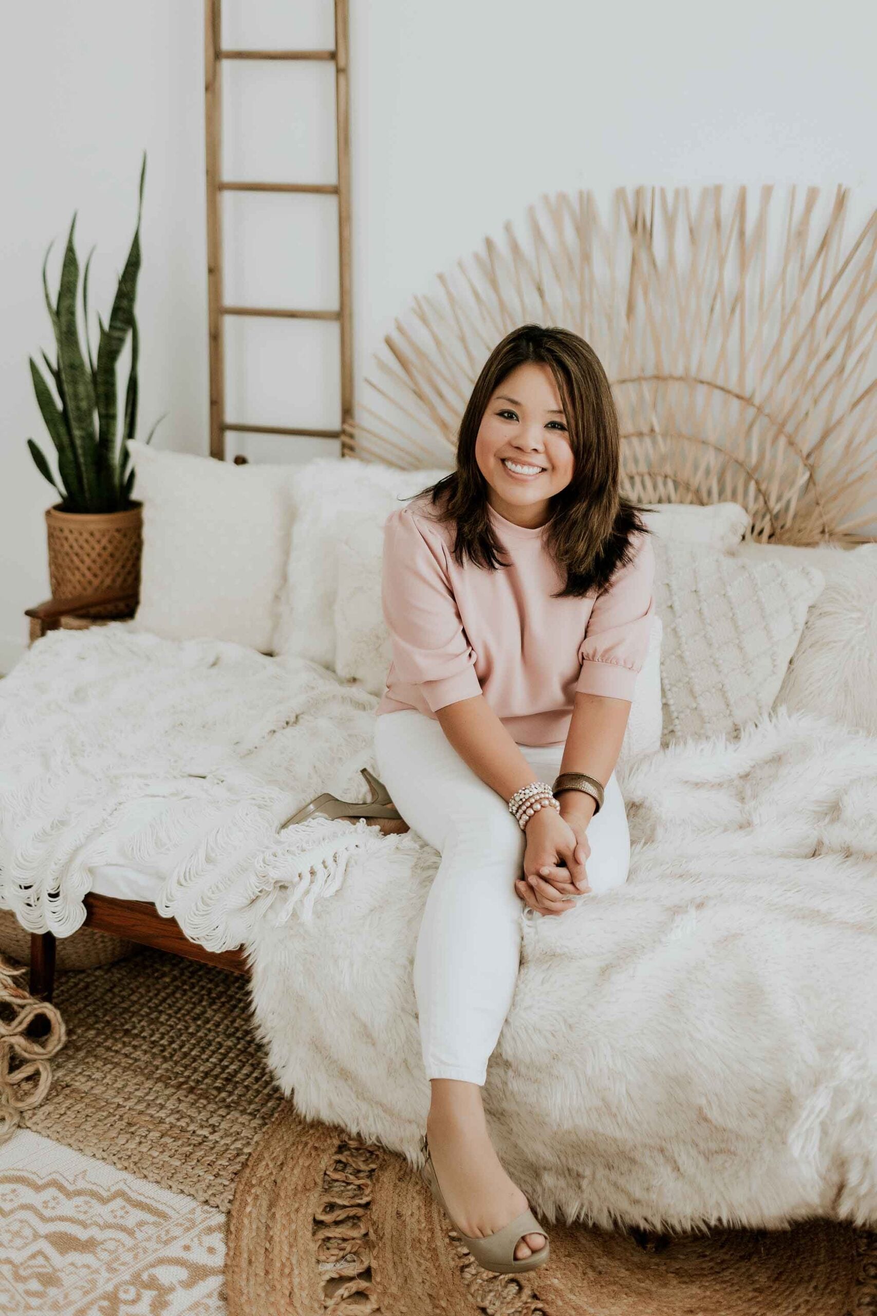 blogger seng nickerson sitting on sofa posting for photos