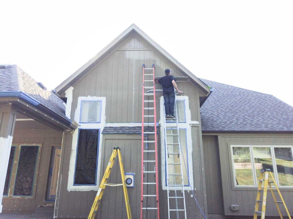 keep the spray gun moving when painting man on ladder