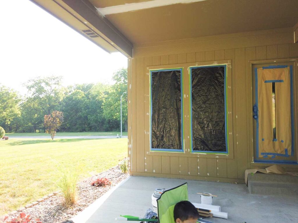 house taped up under patio with painters tape and plastic