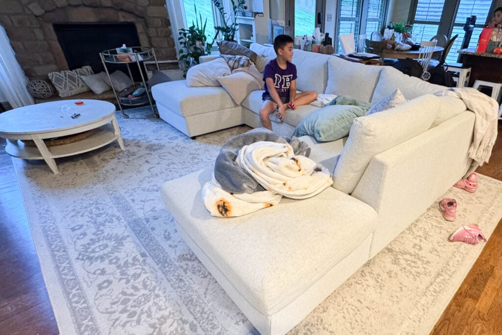 Storage inside IKEA Finnala sectional ottoman with lid lifted in family living room