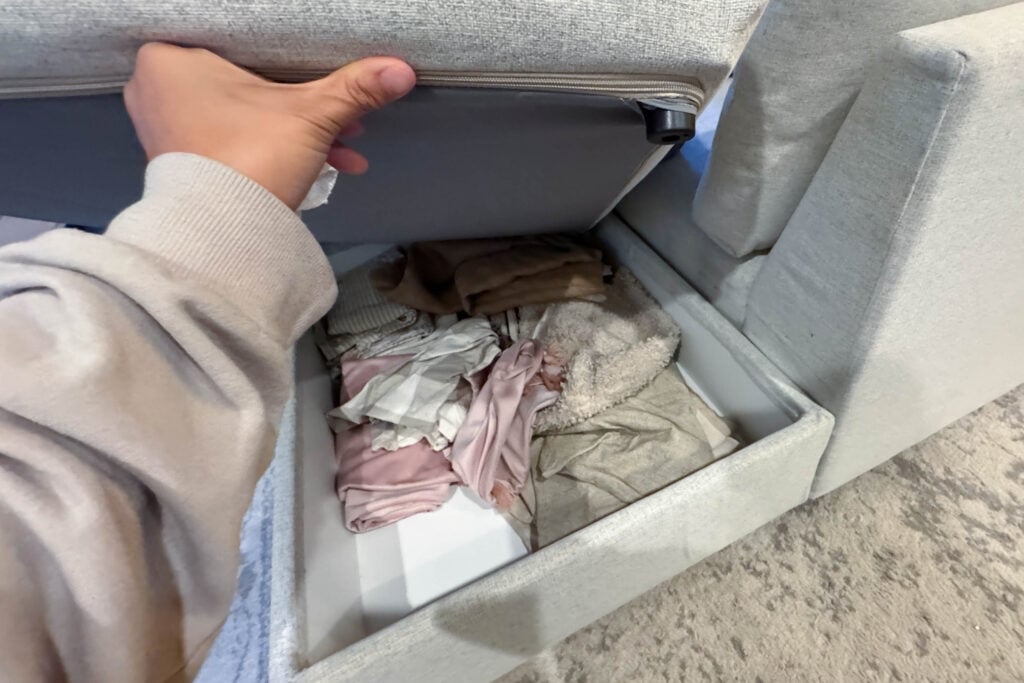 IKEA Finnala sectional ottoman lifted to display built-in storage functionality