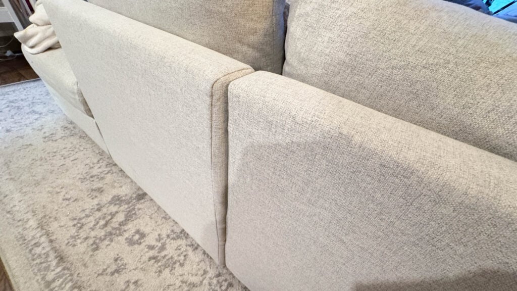 Real-life view of IKEA Finnala back cushions shifted from kids jumping and movement